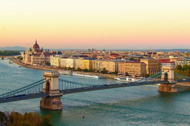 Budapeşte 'nin sonbahar manzaralı günbatımı. Arka planda Tuna Nehri üzerindeki Zincir Köprüsü ve Macar Parlamento Binası 'nın resmi manzarası var. Seyahat ve turizm konsepti. Budapeşte, Macaristan
