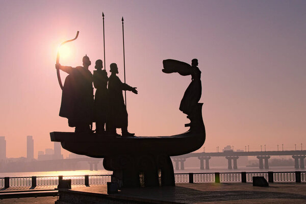 Picturesque view of the silhouette of famous Monument to legendary founders of Kyiv: Kiy, Schek, Khoryv and their sister Lybid on Dnieper river coast. Haze in the morning during sunrise. Kyiv,Ukraine.