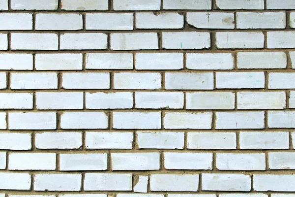 Background of white brick wall texture. Close-up view of cement bonded brick wall. Brick wall with different white colors stones. Outdoor and indoor interiors. Stone block seamless background.
