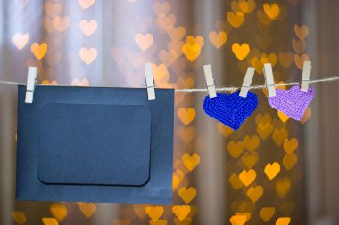 Clothespin iki örgü kalp ve fotoğraf kareleri.