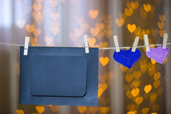 Two knitted heart and photo frames on the clothespin. — Stock Photo, Image