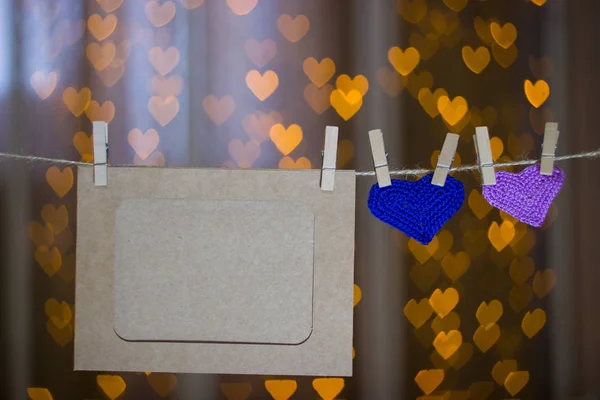 Two knitted heart and photo frames on the clothespin. — Stock Photo, Image
