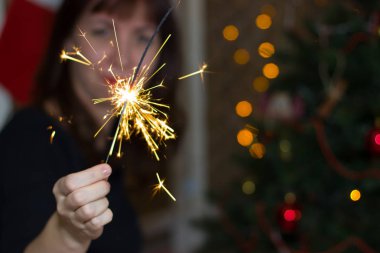 Maytap ile Noel ağacı yakınındaki kız. 