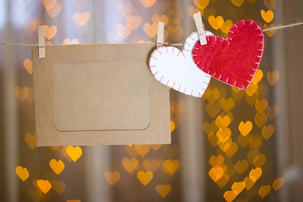 Photo frames and two hearts made of felt.