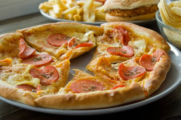 Unhealthy concept. unhealthy food: Burger, sauce, potatoes, pizz