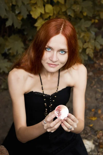 Halloween Witch with a magic Pumpkin in a dark forest. — Stock Photo, Image