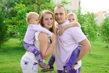 Parkta eğleniyor dört kişilik bir aile. 