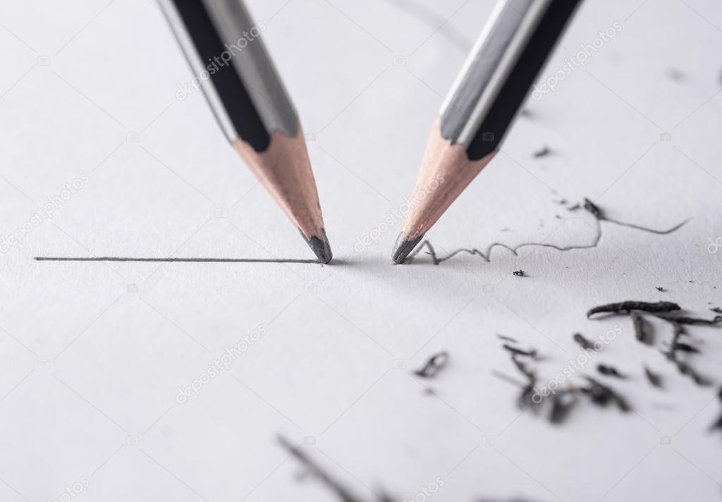 Close up of a sharpened pencil writing a straight line