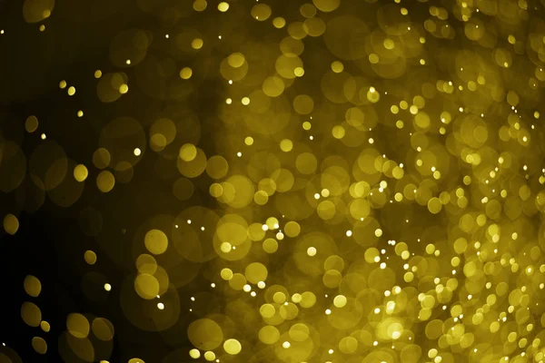 Bokeh luz de oro sobre fondo negro — Foto de Stock