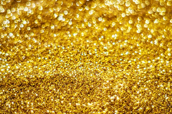 Glitter light abstract gold bokeh blurred background