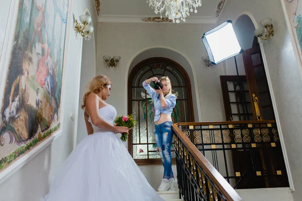 Jovem fotógrafo sexy está tirando fotos da noiva — Fotografia de Stock