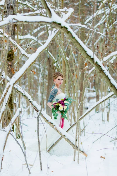 Retrato de la novia en el frío bosque de invierno con un hermoso ramo de novia — Foto de Stock