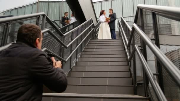 Fotograf care fotografiază doi proaspeți căsătoriți — Videoclip de stoc