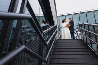 Güzel çift metal bir merdiven üzerinde yeni evliler