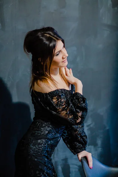 Brunette posing near black wall in the studio — Stock Image Brunette posing near black wall in the studio Stock Photo