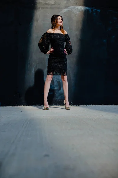 Brunette posing near black wall in the studio — Stock Image Brunette posing near black wall in the studio Stock Image