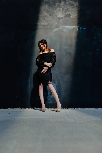 Brunette posing near black wall in the studio — Stock Image Brunette posing near black wall in the studio Stock Image