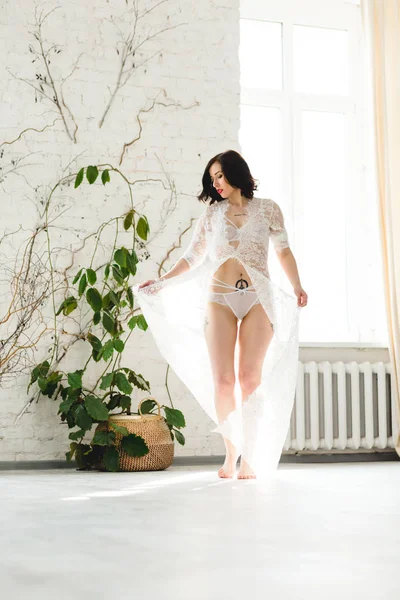 Sexy bride dancing near the big window — Stock Photo, Image