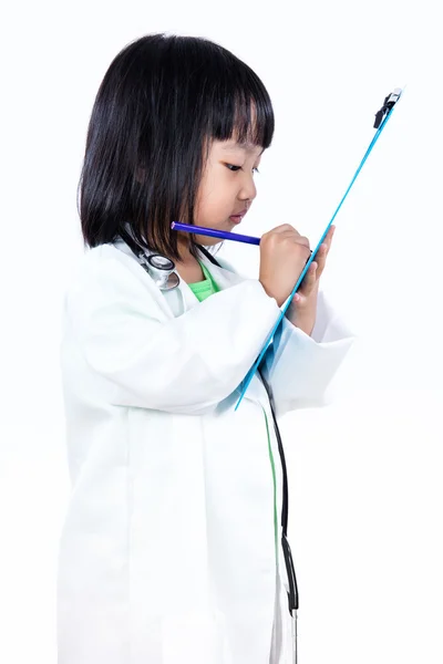 Asian Chinese Little Doctor Writting On Clip Board Stock Image