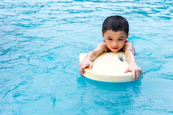 Asiático chinês menino nadando com flutuante bordo — Fotografia de Stock