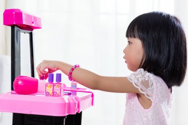 Asyalı Çinli Liitle kız makyaj oyuncaklar ile oynama