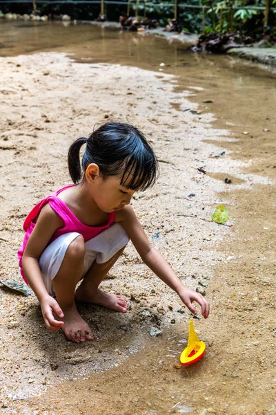 Asiático chinês menina jogar brinquedo barco no riacho — Fotografia de Stock