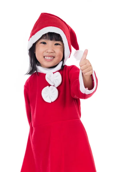 Счастливая азиатская китайская маленькая девочка Санта Клаус с большими пальцами вверх — стоковое фото