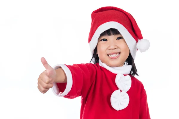 Счастливая азиатская китайская маленькая девочка Санта Клаус с большими пальцами вверх — стоковое фото