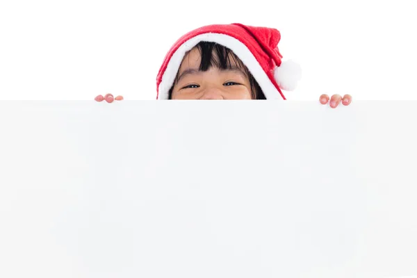 Feliz asiático chino poco santa chica mirando detrás de blanco tablero — Foto de Stock