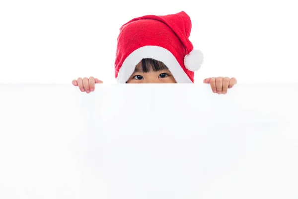 Feliz asiático chino poco santa chica mirando detrás de blanco tablero —  Fotos de Stock