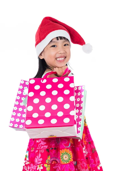 Китайський мало Підлітка пару користується носіння Санта hat з покупки сумка — стокове фото
