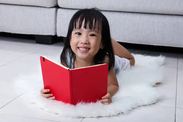 Glücklich asiatische chinesische kleine Mädchen lesen Buch auf dem Fußboden — Stockfoto
