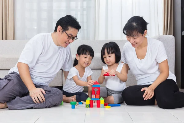 Asian Chinese parents and daughters playing blocks on the floor