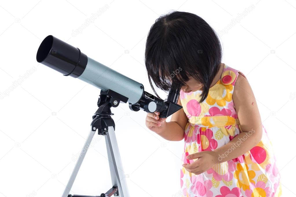 Asian Chinese little girl with telescope