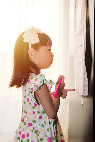 Asiatico cinese bambina scrittura su carta con retroilluminazione — Foto Stock