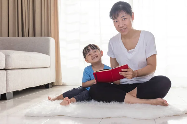 Aziatische Chinese moeder en dochter lezen op de verdieping — Stockfoto