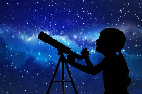 Silhouette of little girl looking through a telescope — Stock Photo, Image