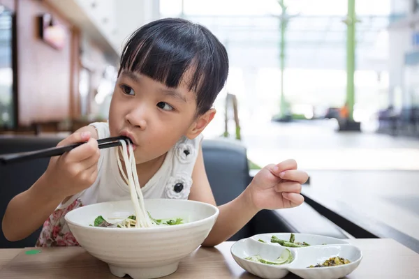 Asiatiska liten kinesisk flicka äter Nötkött nudlar soppa — Stockfoto