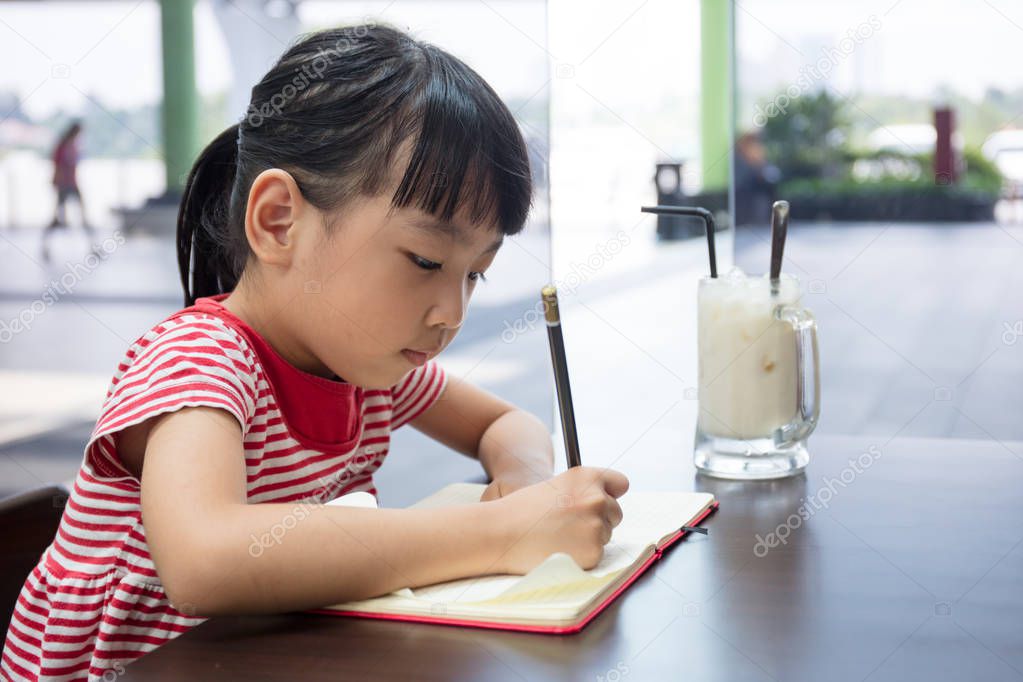 Asian Chinese little girl doing homework