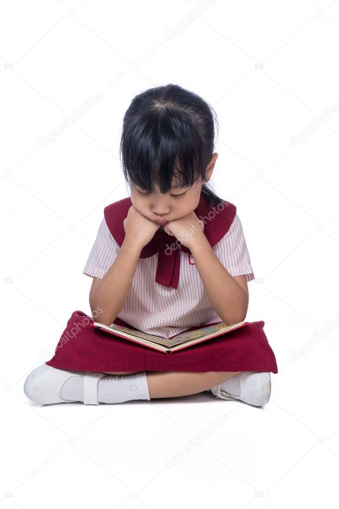 Asian Little Chinese girl sitting on floor and reading book