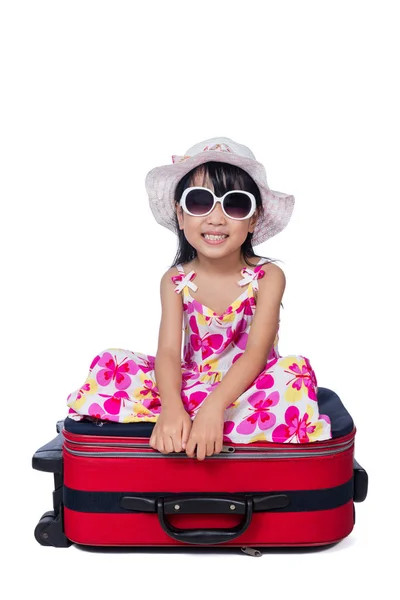 Happy Asian Little Chinese girl sitting on a suitcase — Stock Photo, Image