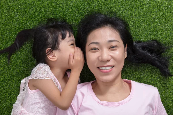 Asian Chinese mother and daughter whispering and gossiping — Stock Photo, Image