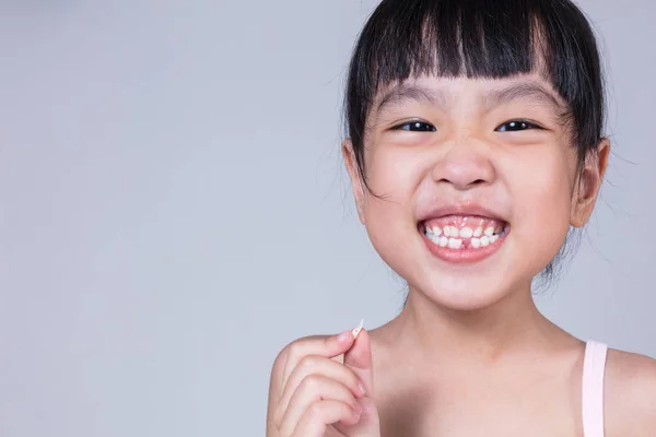 Asiatique chinois petite fille tenant sa dent manquante — Photo