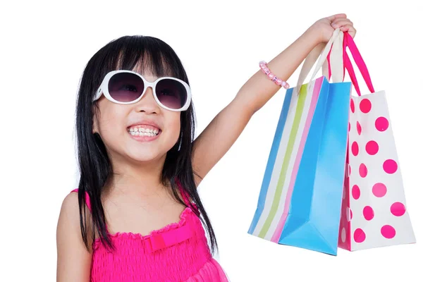 Asian Chinese little girl holding shopping bags — Stock Photo, Image