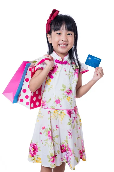 Asian Chinese little girl holding shopping bags with credit card — Stock Photo, Image