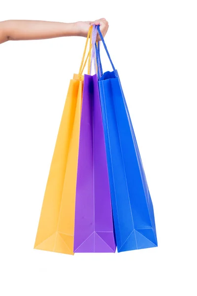 Mano del niño sosteniendo bolsas de compras coloridas — Foto de Stock
