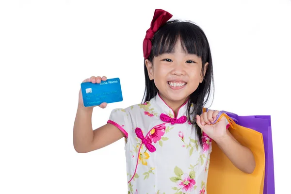 Asian Chinese little girl holding shopping bags with credit card — Stock Photo, Image