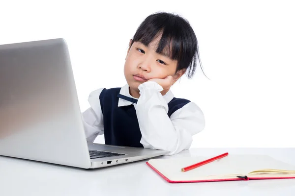 Asian Chinese little girl in uniform studying with laptop — Stock Photo, Image