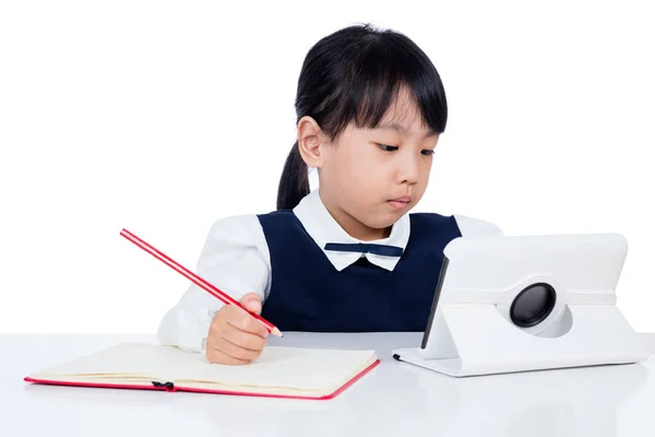 Asian Chinese little girl in uniform studying with tablet comput — Stock Photo, Image