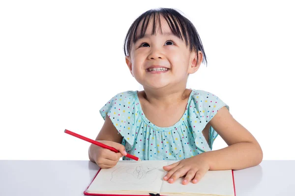 Asiático menina chinesa escrevendo no caderno de exercícios — Fotografia de Stock